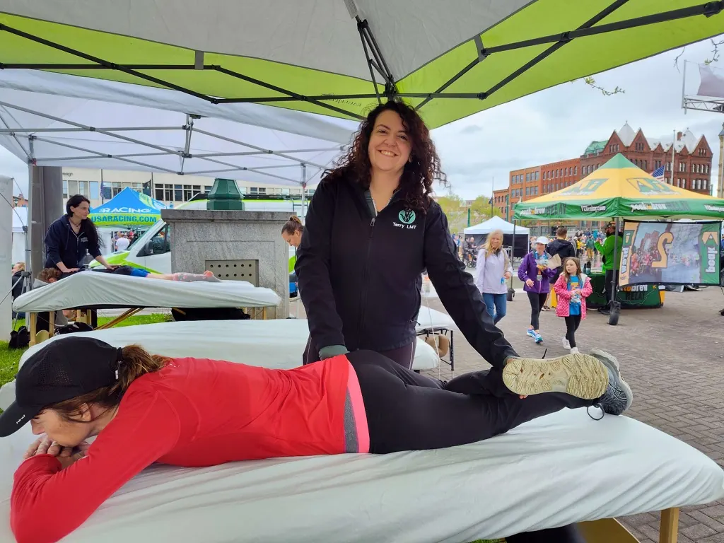 Runner getting a post-race recovery massage from a Hand in Health therapist at the Mountain Goat Run