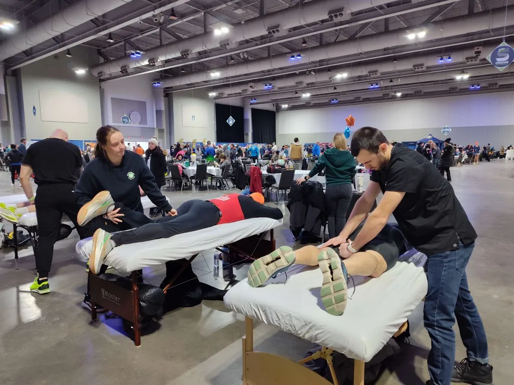 Hand in Health massage therapists giving free post-race massage at the Syracuse Half Marathon